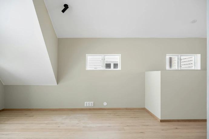 An empty room with white walls and wooden floors